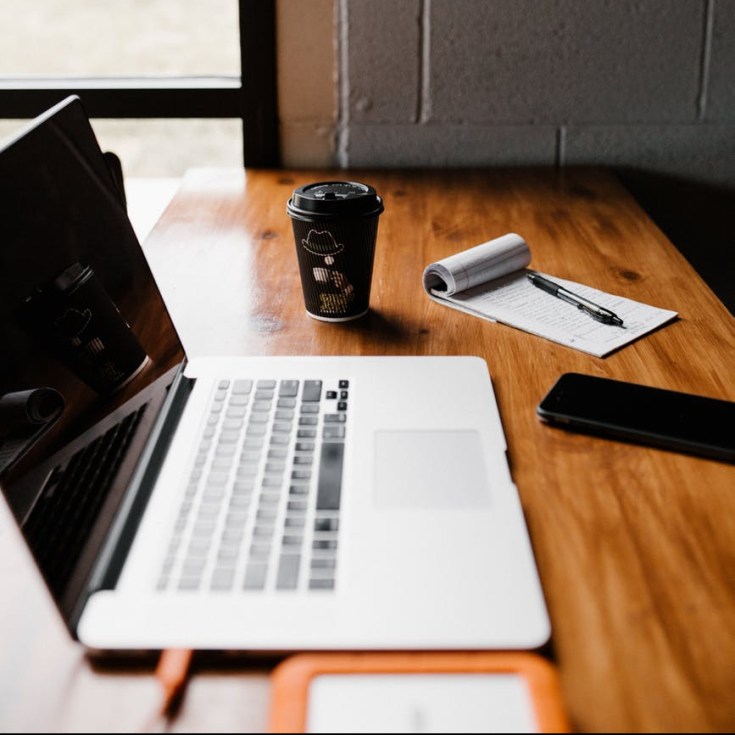 silver macbook pro on tabletop